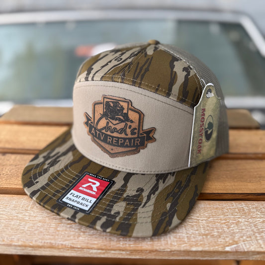 Mossy Oak Bottomland Chad’s ATV Repair 7 Panel Trucker Hat